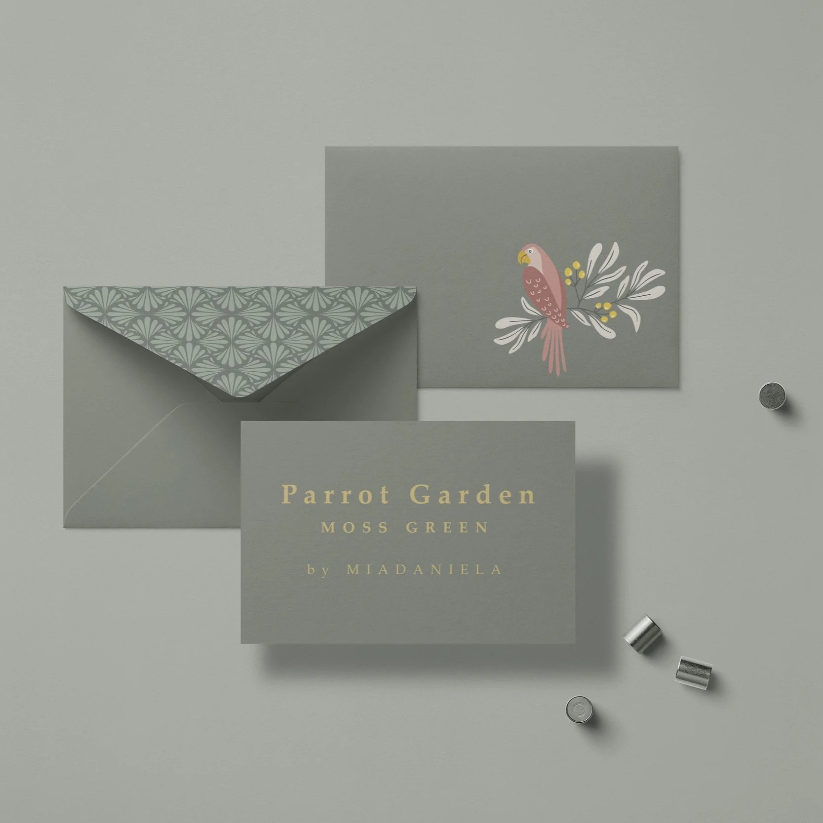 Premium stationery mockup featuring the Parrot Garden collection in the Moss Green colorway applied to greeting cards and coordinated paper goods.