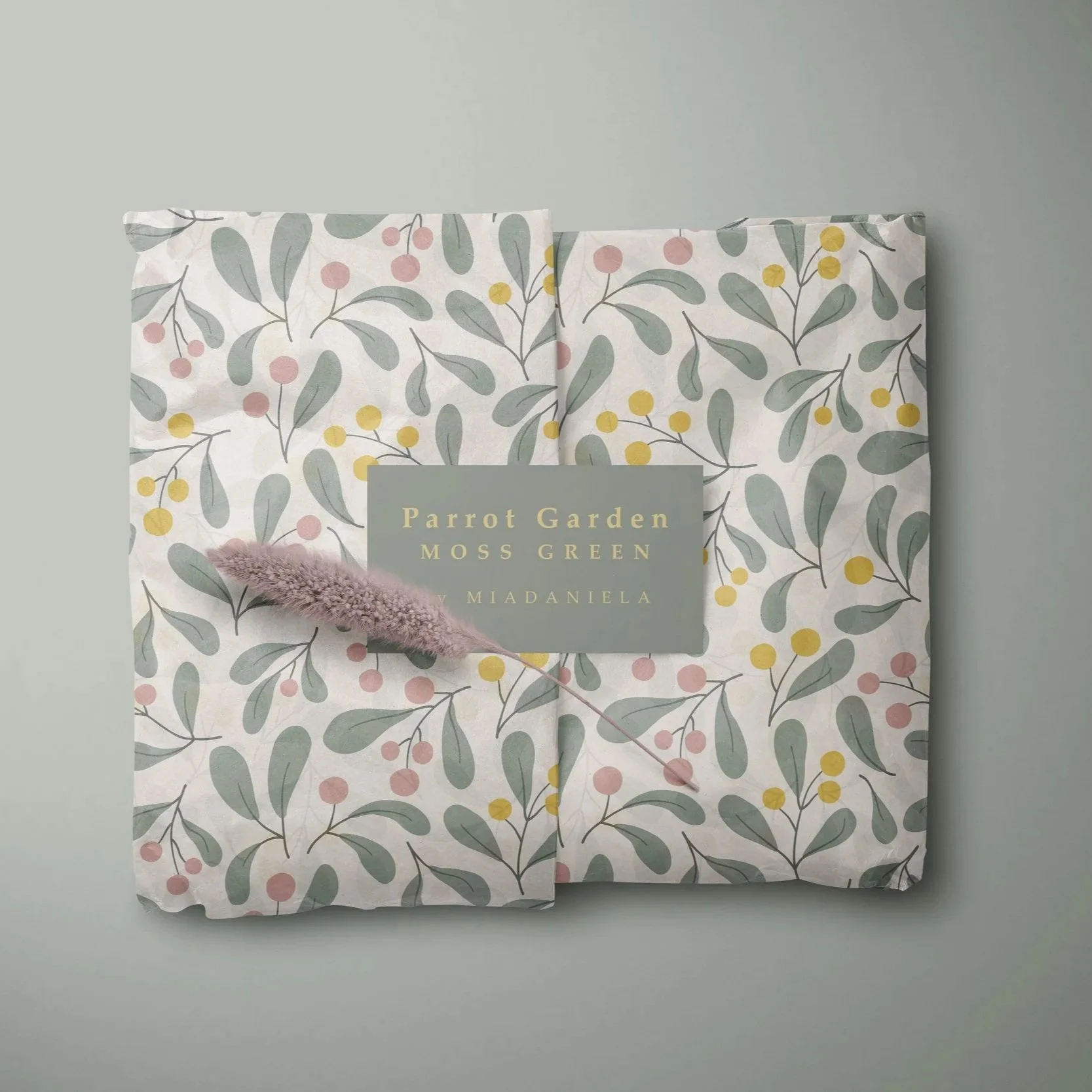Gift wrap mockup featuring the Parrot Garden collection in the Moss Green colorway with coordinated botanical packaging design.
