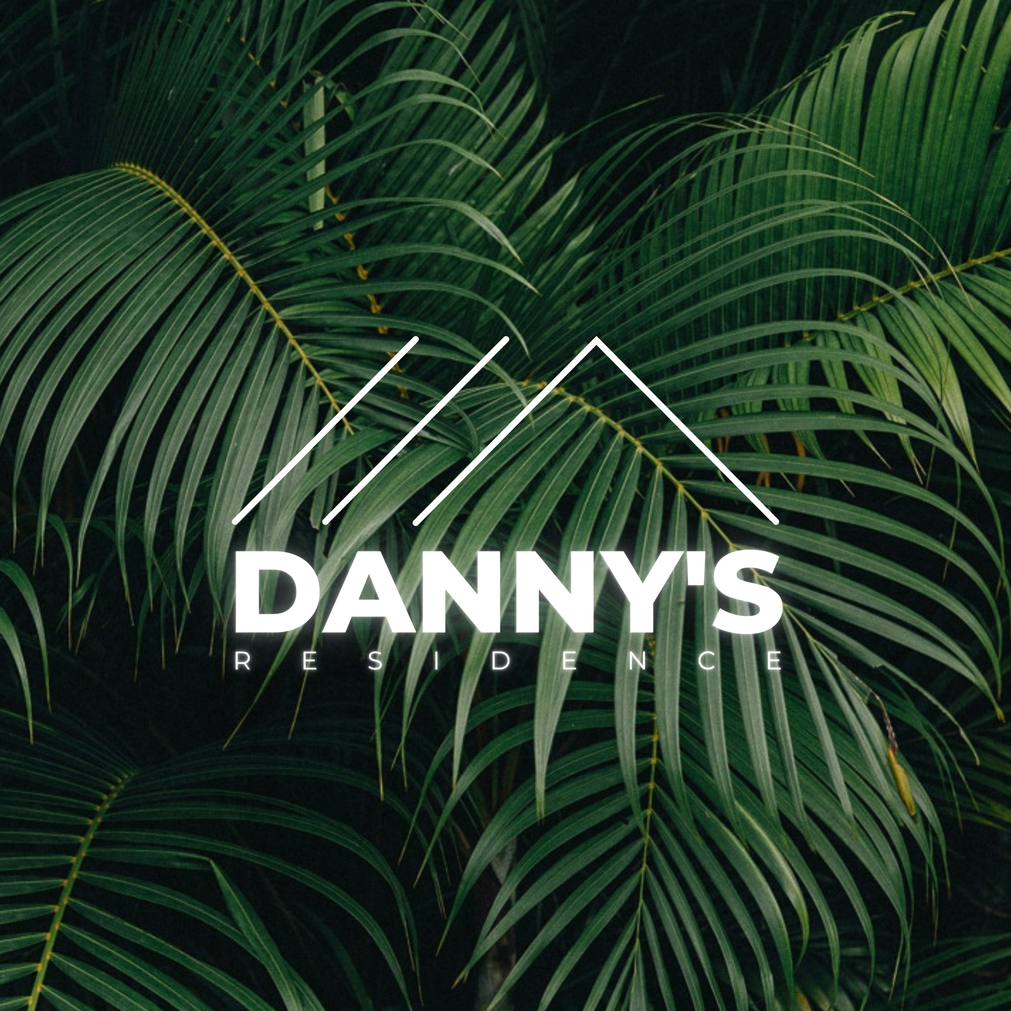 Close-up of lush green palm leaves with the text 'DANNY'S RESIDENCE' overlayed in white.