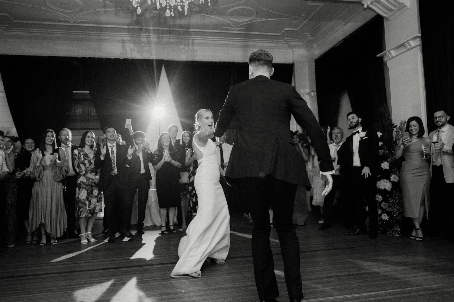 A bride and groom are dancing at their wedding reception, surrounded by guests watching and smiling - Southern Highlands Wedding Venue and Photographer, The Robertson Hotel.
