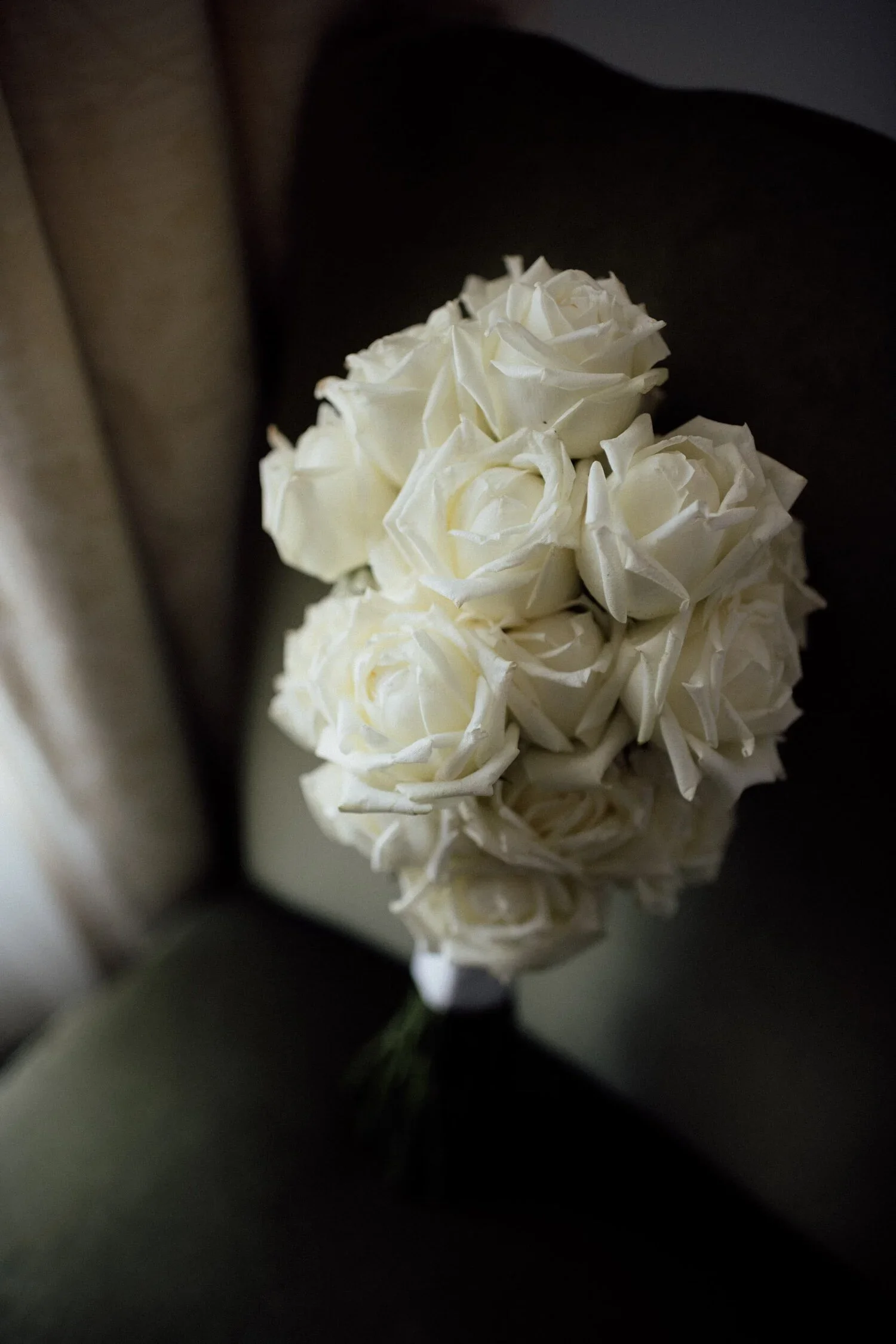Close-up of a bouquet of white roses with a blurred background.