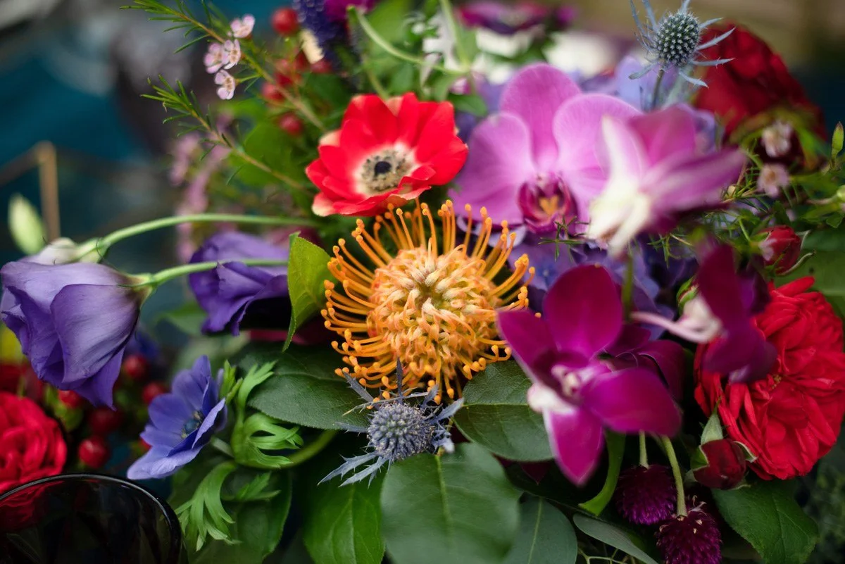 Close up of bright protea and anemone floral centerpiece
