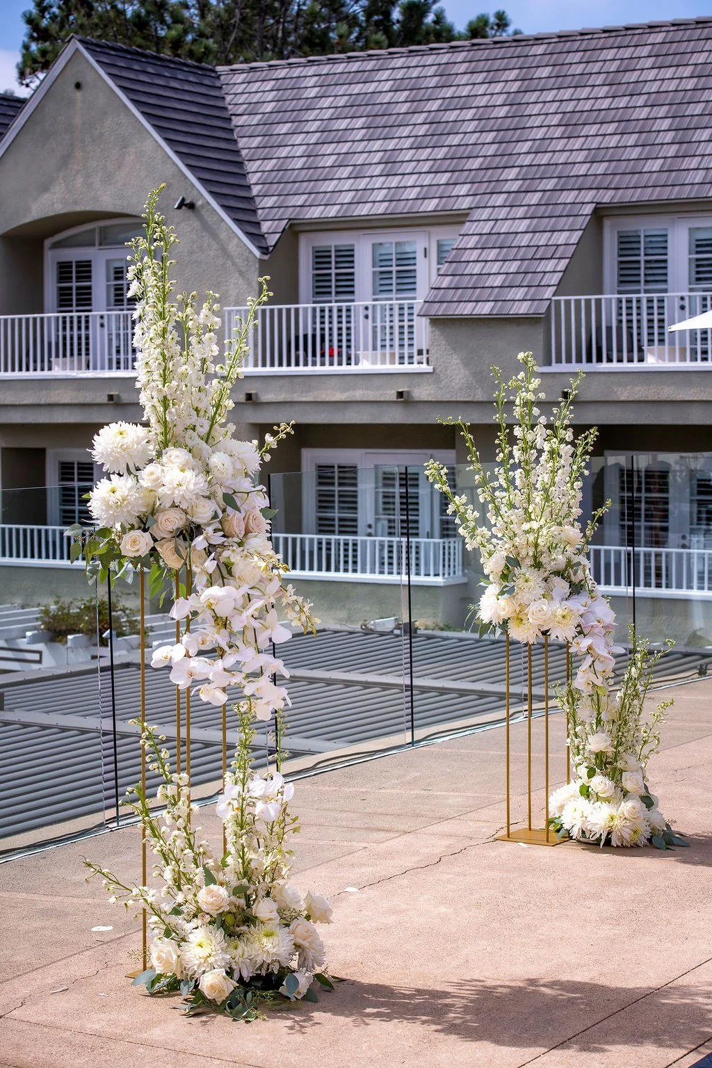 wedding-floral-columns-gold-stands-outdoor-ceremony.jpg