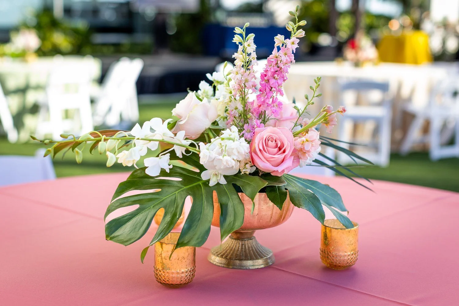 Pink roses and monstera leaf floral centerpiece