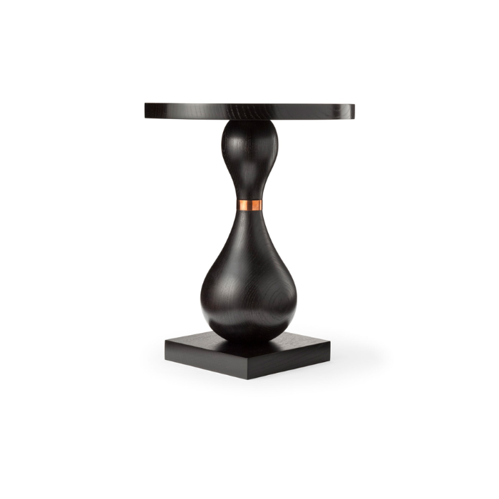 Black wooden side table with a sculptural base and a round top, on a white background.