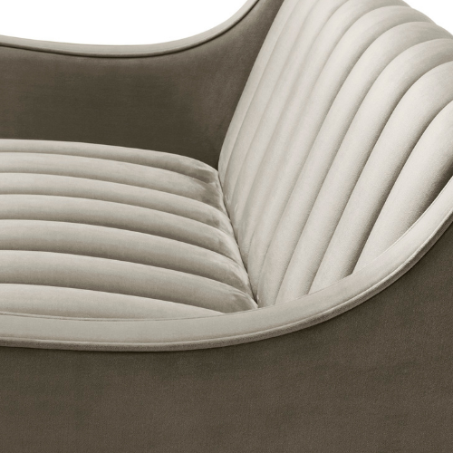 Close-up of a beige upholstered vintage sofa with vertical channel tufting.