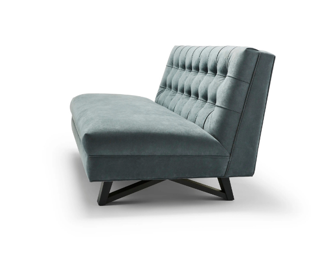 Light gray upholstered modern sofa with tufted back and angled black wooden legs on a white background.
