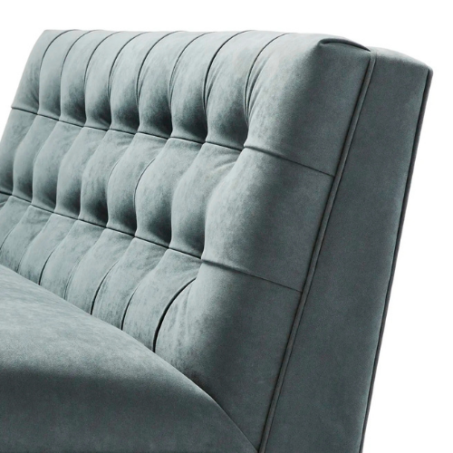 Close-up of a light gray upholstered headboard with tufted design and vertical lines.