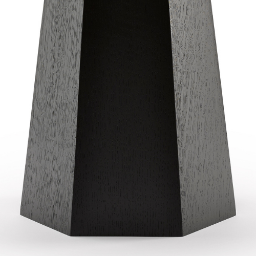 Close-up of a black, hexagonal wooden speaker stand or base.