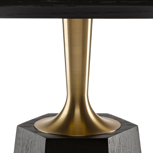 Close-up of a modern table with a metallic gold base and a dark tabletop.