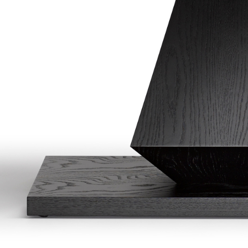 Close-up of a black wood base with a vertical black wood panel resting on top, set against a white background.