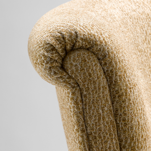 Close-up of a beige upholstered armchair armrest with textured fabric.