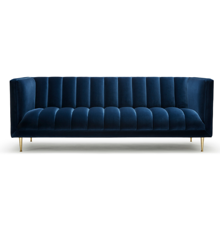 A dark blue velvet sofa with vertical channel tufting and gold legs.