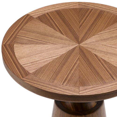 Close-up of a round wooden table top with a geometric pattern of wooden segments.