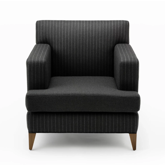 Dark gray armchair with pinstripe pattern and wooden legs against a white background.