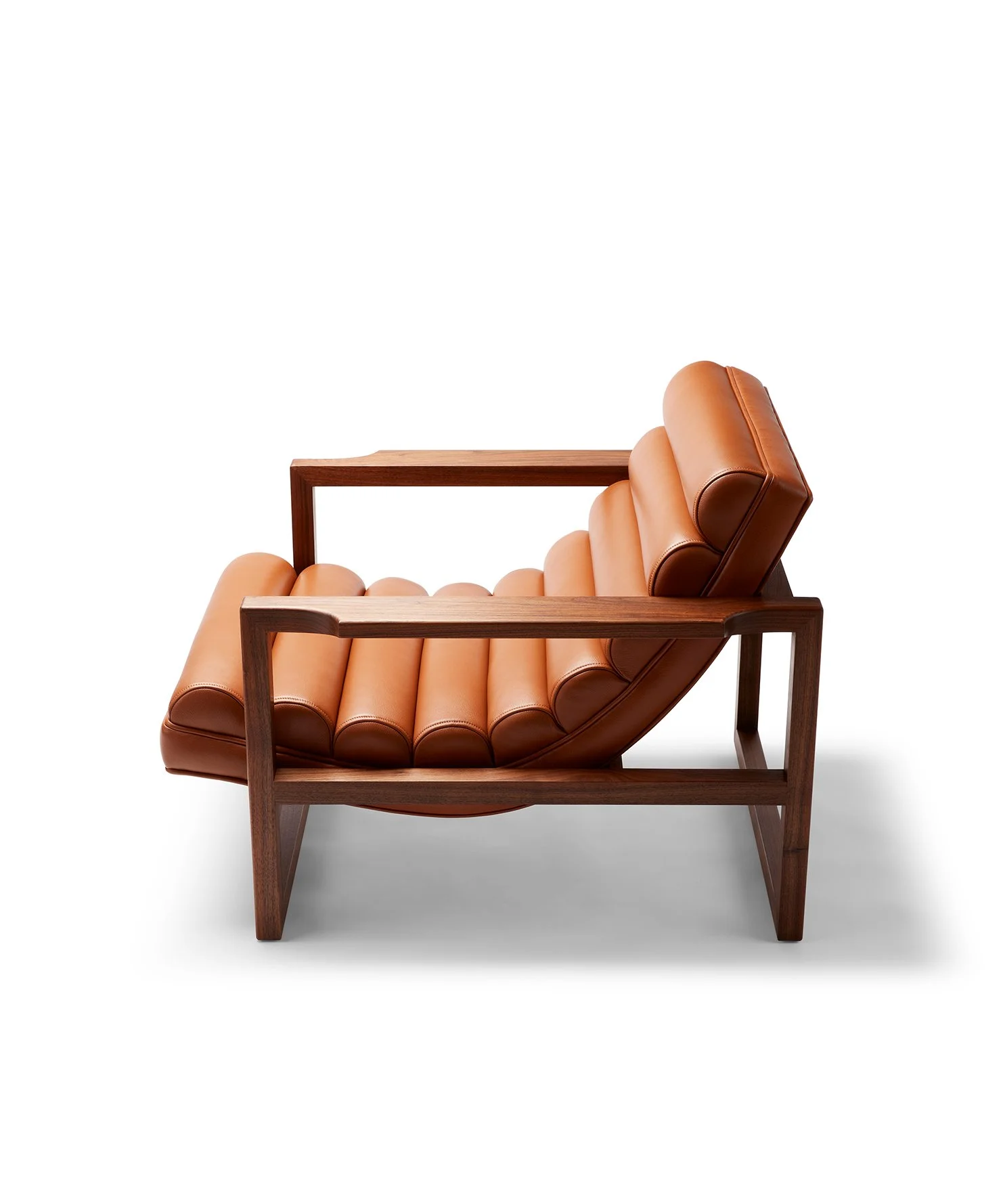 A modern lounge chair with a wooden frame and tan leather cushion.