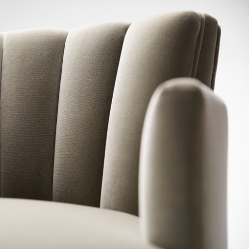 Close-up of beige upholstered chairs with rounded backs.