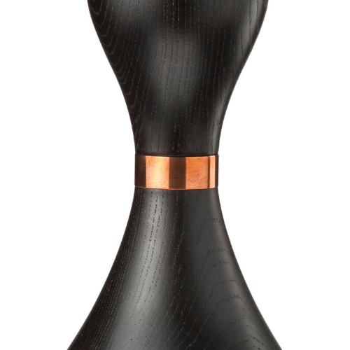 A black hourglass-shaped object with a copper band in the middle.