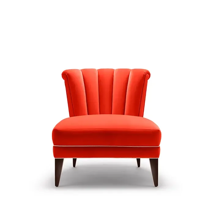 Red upholstered armchair with dark wooden legs on a white background.