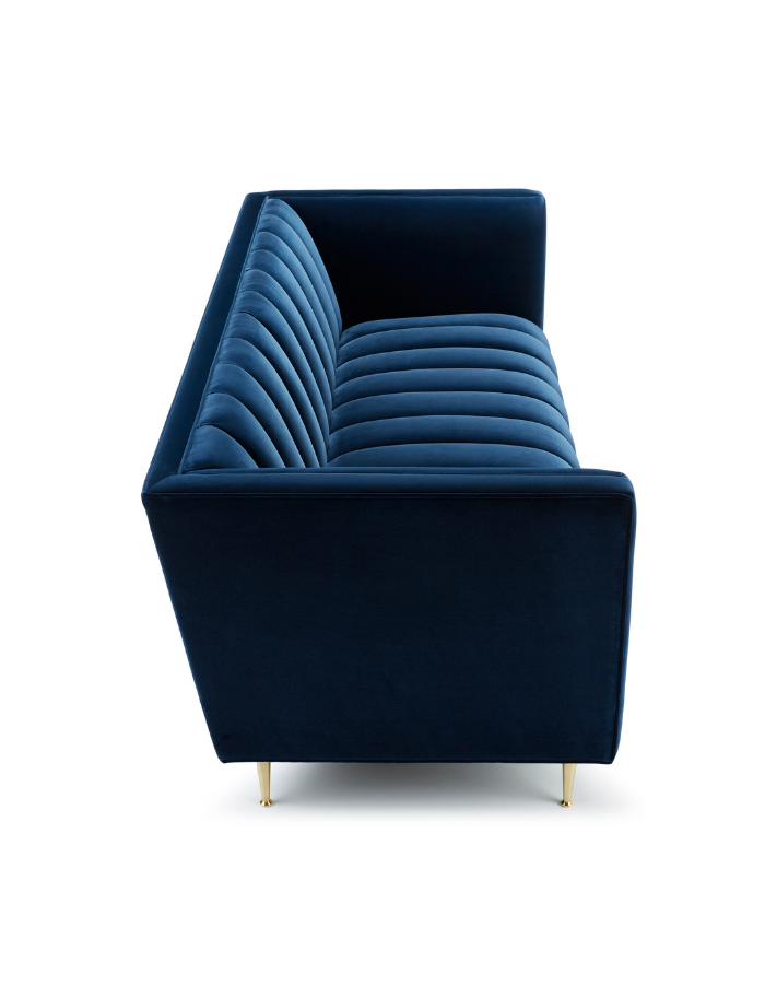 A modern, navy blue velvet sofa with gold-tipped legs, viewed from the front at a slight angle.
