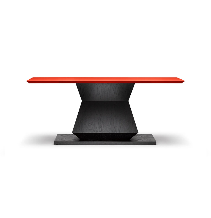 Modern dining table with a red top and black base.