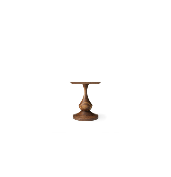 A wooden side table with a unique, curvy pedestal base and a flat top, set against a white background.