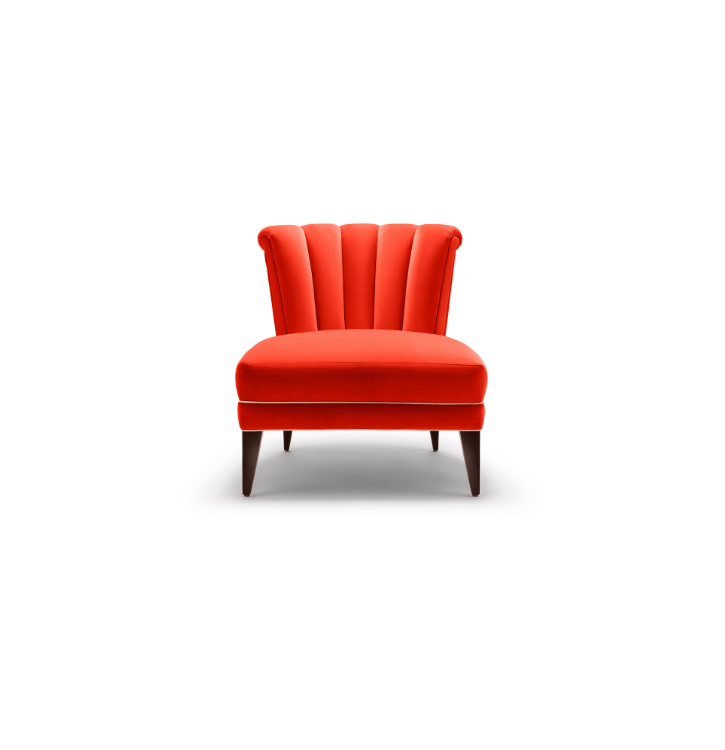 Red upholstered armchair with vertical tufting on the backrest and wooden legs, against a white background.