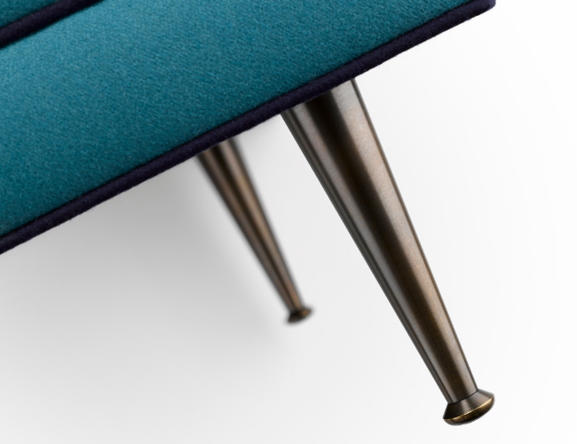 Close-up of a modern teal chair with metallic legs.