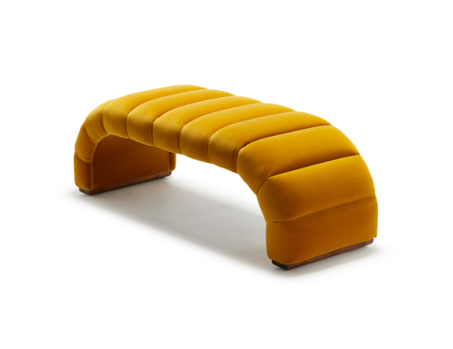 Yellow upholstered curved bench with padded sections on white background.