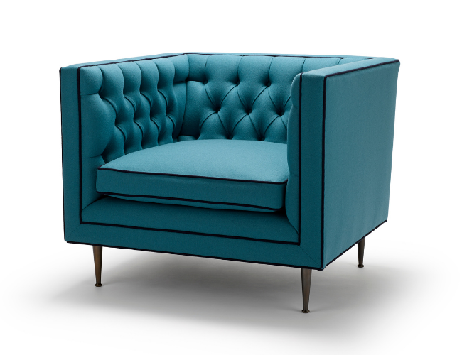 Teal upholstered armchair with button tufting and dark wooden legs.