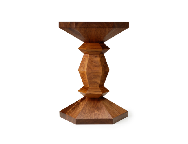 Wooden table with geometric design and a hexagonal base.