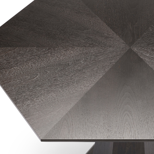 Close-up of a dark wood tabletop with a geometric pattern.