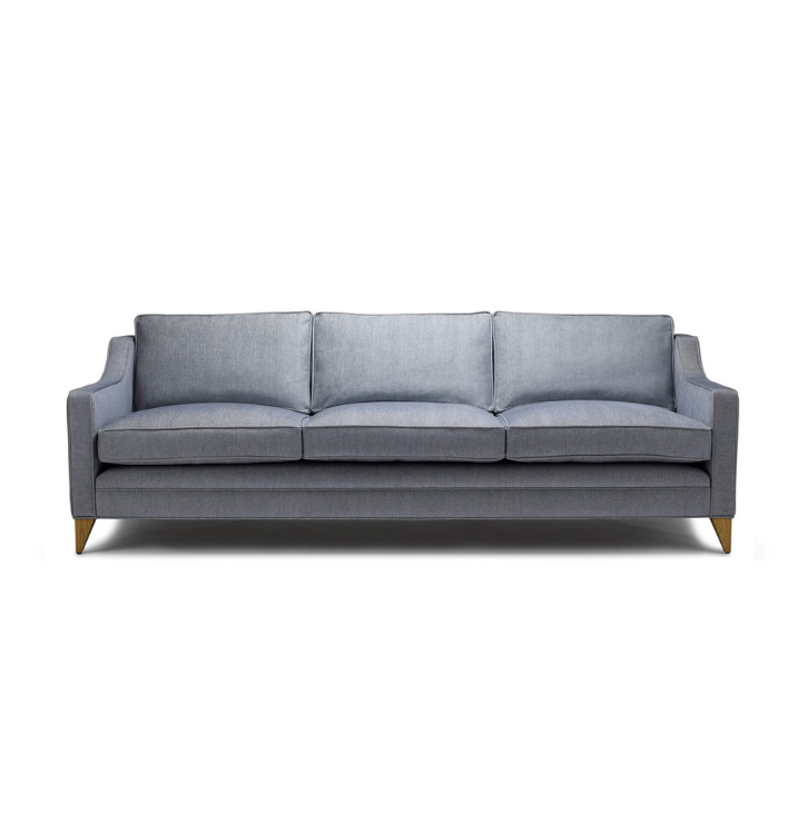 A light gray, modern three-seater sofa with wooden legs, set against a plain white background.