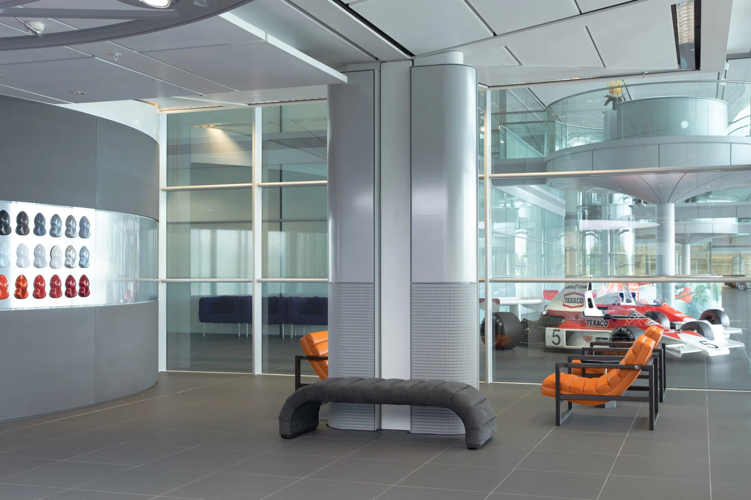 Stuart Scott Furniture's collaboration with McLaren extended to its Technology Centre, featuring grey velvet Fleur Benches, hot orange leather covered Florence Easy Chairs and Black Lacquered Walnut Hex Side Tables