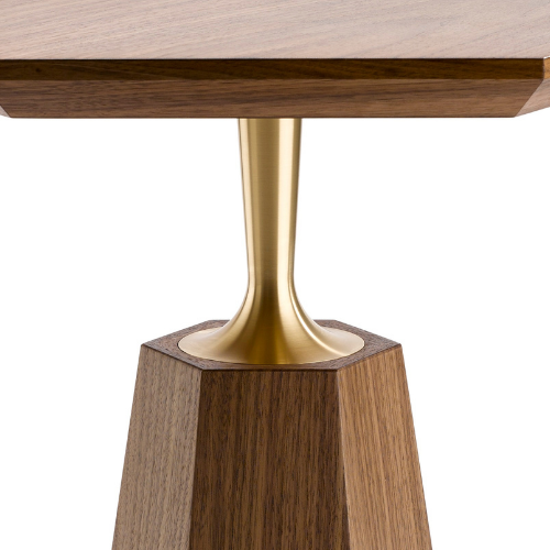 Close-up of a wooden table with a metal leg attached to a wooden base.