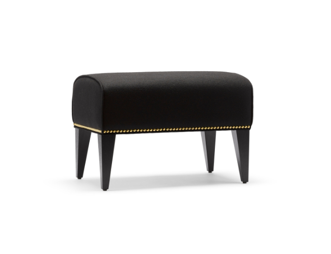 Black upholstered bench with gold nailhead trim and tapered wooden legs.