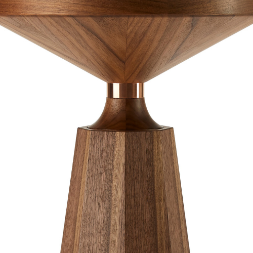 Close-up of a wooden table leg and corner of the tabletop showing a modern design with a metal accent at the joint.