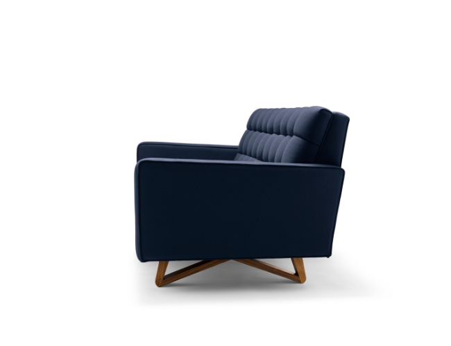 A navy blue modern armchair with wooden legs on a white background.