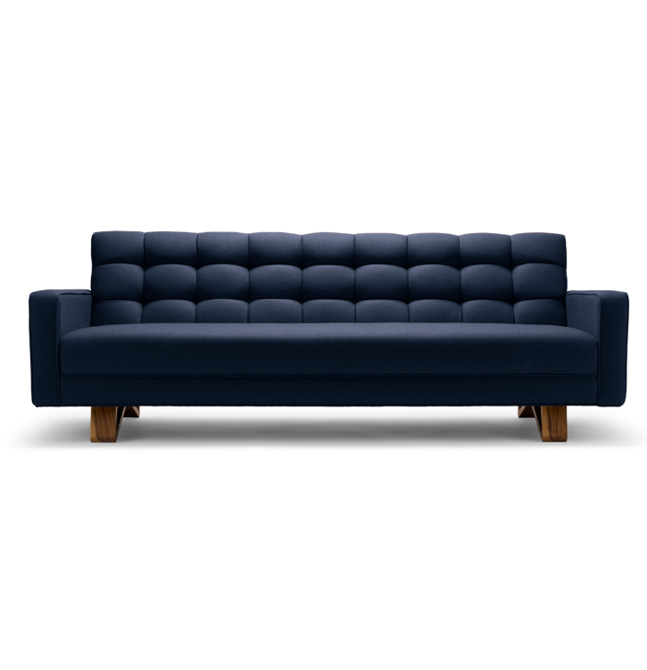 Navy blue mid-century modern tufted sofa with wooden legs.