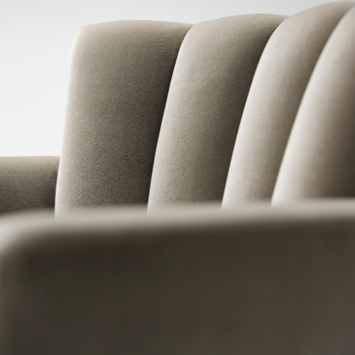 Close-up of padded beige theater or auditorium seats with curved backs