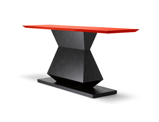 Modern wooden table with a red top and black angled base on a white background.