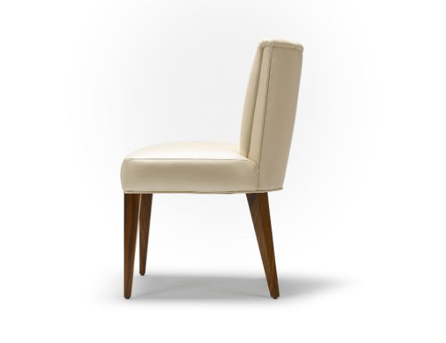 Cream-colored chair with wooden legs on a white background.