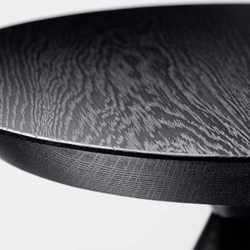Close-up of a black wooden table surface showing wood grain texture.