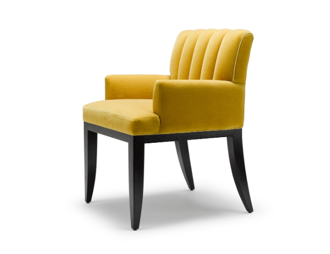 A yellow upholstered chair with black wooden legs and a curved backrest.