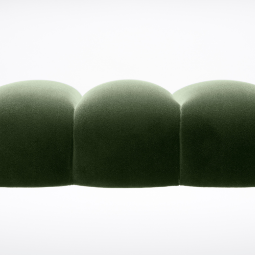 Close-up of three green upholstered rounded cushions or ottomans arranged in a row against a white background.