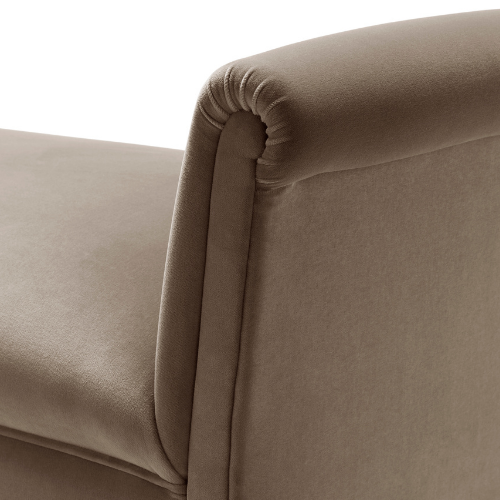 Close-up of a beige upholstered armchair with rounded armrest.