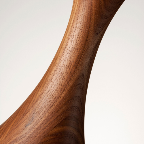 Close-up of a wooden object with a smooth finish and curved shape.