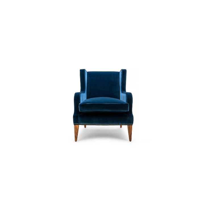 A blue velvet wingback armchair with wooden legs on a white background.