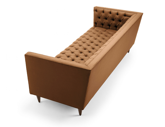 Brown tufted chaise lounge with angled backrest and wooden legs.