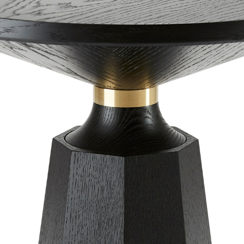 Close-up of a black wooden table leg with a gold ring connecting the leg to the tabletop.